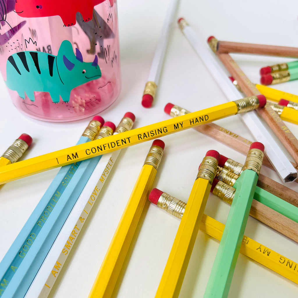 Affirmation Pencil set of 7. imprinted with I am confident raising my hand, i am smart and i love myself, and I am a good problem solver. colors are white, natural wood, and pastel yellow, pastel blue and pastel green for positive back to school supplies.