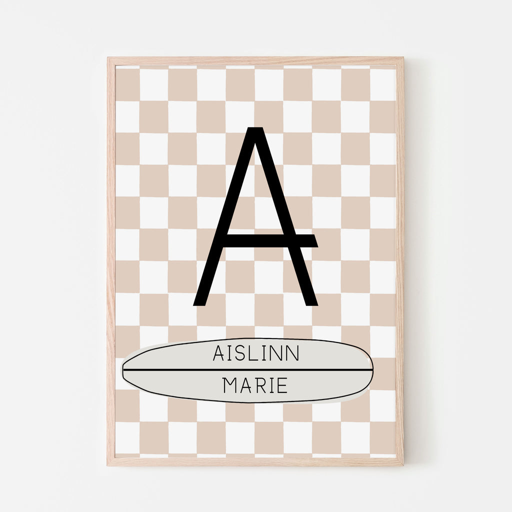 Peach and white checkered background with a large letter and child's first and middle name on a horizontal longboard surfboard. Personalized name sign for baby nursery room, kids bedroom and playroom
