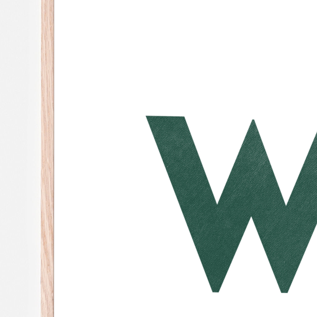 Close up image of WILD wall art spelled in Dark green letters with a white background